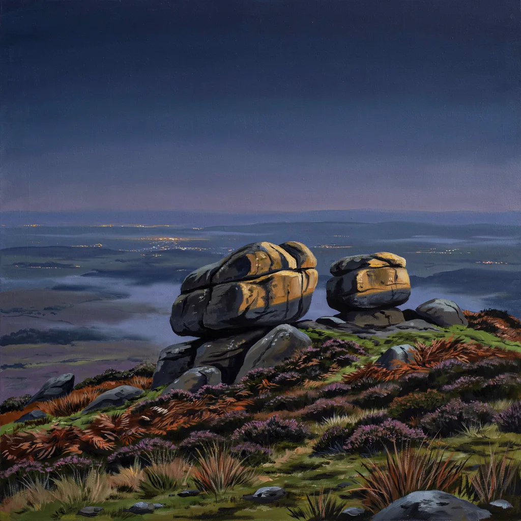 A lit bay window in a dark Yorkshire stone house on the moors at dusk